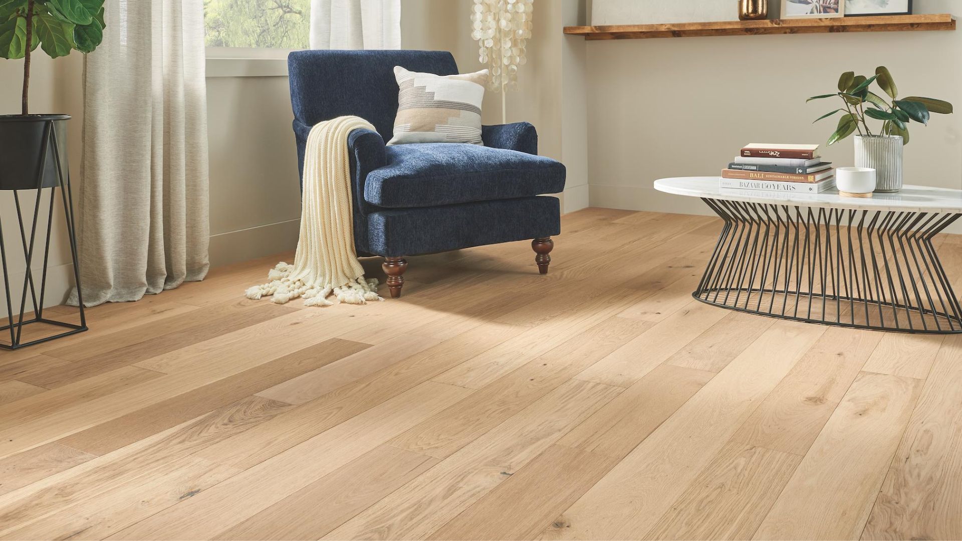 Hardwood flooring in living space, table, blue chair
